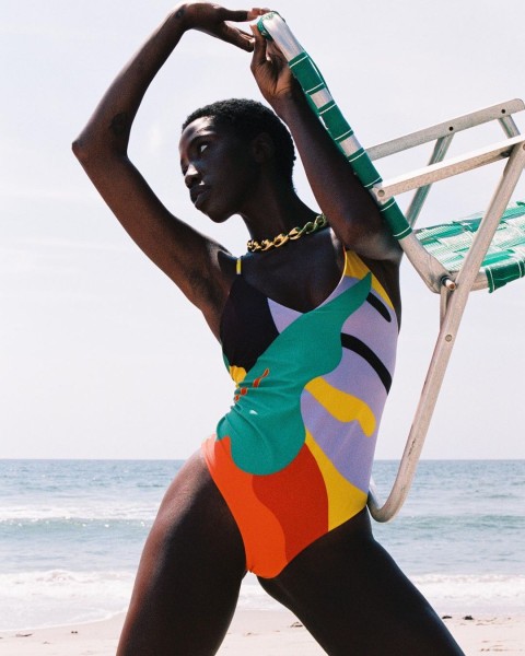 Woman wears colorful Mara Hoffman swimsuit